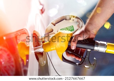 Young man, fill diesel tank of car after finish refill diesel oil in gas station Royalty-Free Stock Photo #2127667667