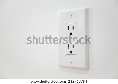 White Electrical Outlet and Wall Plate at the white wall Royalty-Free Stock Photo #212768794