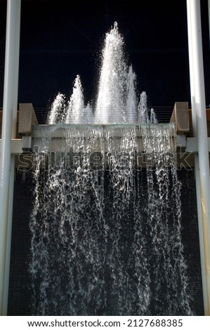 fast exposure of a two story waterfall on the outside of a building, conceptual