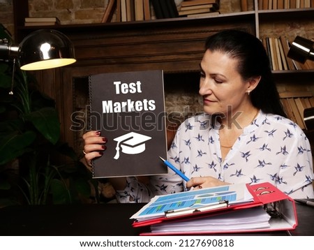 Business concept meaning Test Markets with phrase on blank notepad in hand.
