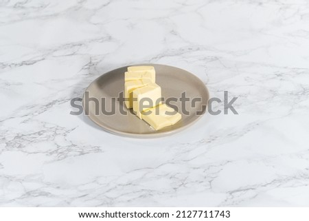 Softened sticks of unsalted butter on the kitchen counter. Royalty-Free Stock Photo #2127711743