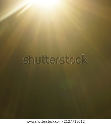 blurred image. shiny sun, sunbeams, sunrays, sunshine design. Yellow warm light effect, sun rays, golden beams isolated on black background. star dust Royalty-Free Stock Photo #2127713012