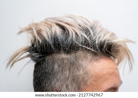 Undercut hairstyle with highlighted hair on a woman's head. Close up. Stylish hairstyle. Royalty-Free Stock Photo #2127742967