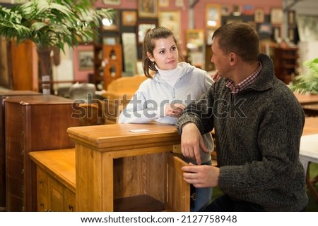Married couple chooses new furniture in the store. High quality photo