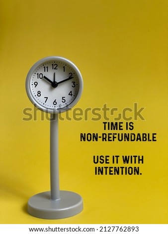 A quote concept with a grey stand clock with the yellow background.