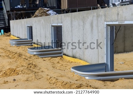 Residential on a new home installation window well for basement construction Royalty-Free Stock Photo #2127764900