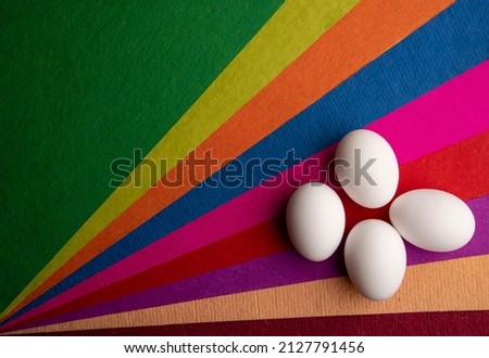 Easter eggs on top of colorful papers