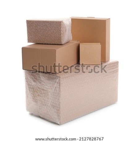 Cardboard boxes packed in bubble wrap and ordinary ones on white background