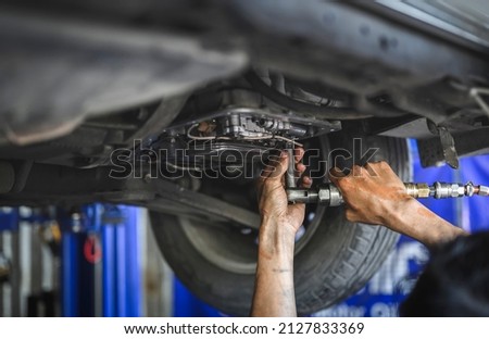 Automatic transmission flushes and fluid replacements service in garage service shop. Royalty-Free Stock Photo #2127833369