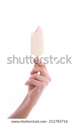 Hand holds bitten  vanilla ice cream. Isolated on a white background.