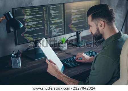 Photo of focused editor guy sit desktop read daily routine plan writing server development in modern workspace