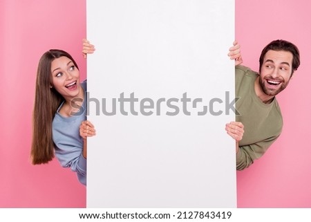 Portrait of two astonished positive persons peek look empty space sale promotion isolated on pink color background Royalty-Free Stock Photo #2127843419