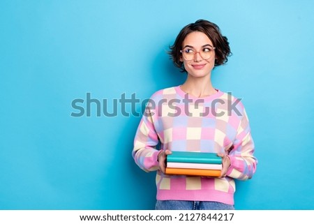 Photo of smart young brunette lady hold book look promo wear eyewear checkered sweater isolated on blue background