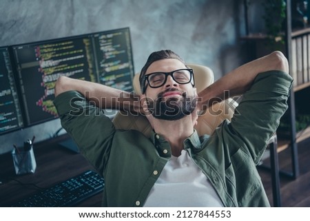 Photo of smiling guy editor hand stretch end operating system start-up debugging optimization sit desk in modern loft workspace
