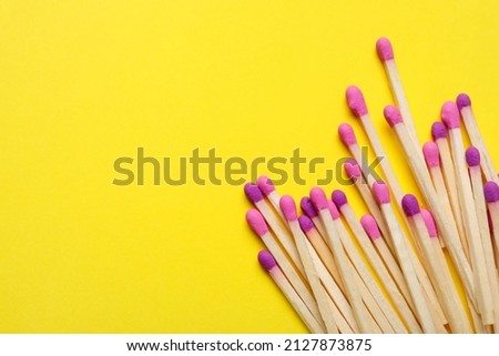 Different new matchsticks on yellow background Royalty-Free Stock Photo #2127873875