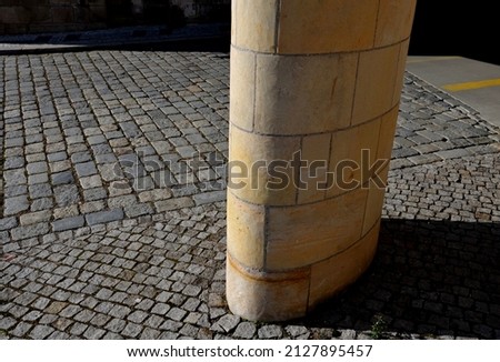 sandstone lookout column made of sandstone blocks in the shape of a cylinder or ellipse. standing on a sidewalk of granite cubes. clean stonemason's work Royalty-Free Stock Photo #2127895457