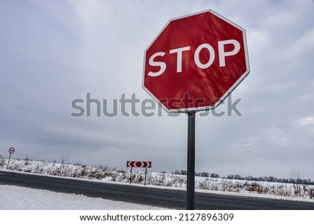 Stop road sign in snowy day in winter.