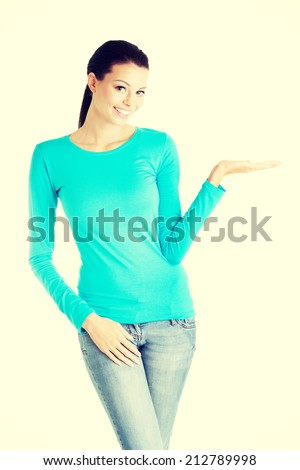 Happy , excited young woman presenting copy space on her palm, isolated on white