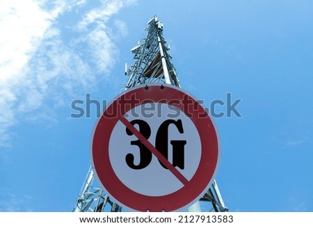 Illustration of the end of life for 3rd generation or 3G cell mobile networks. Road sign with 3G text against rural cellphone tower Royalty-Free Stock Photo #2127913583