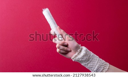 woman's hand holding a medical bandage