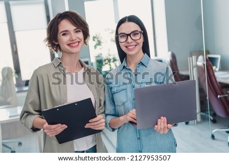 Portrait of two attractive clever smart cheerful leaders executive managers reading documents start-up at workplace workstation indoors Royalty-Free Stock Photo #2127953507