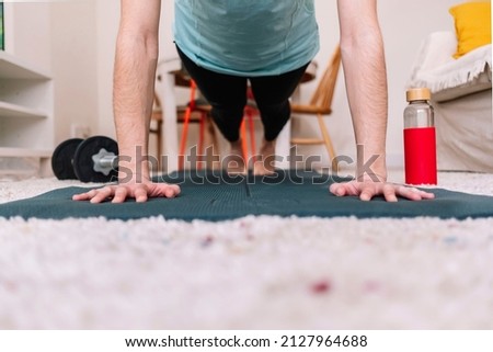 Close-up of a woman's hands on a mat while she does a plank. Fitness concept.
