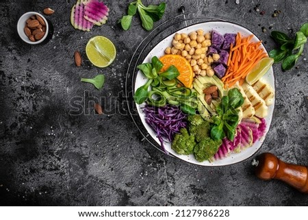 Healthy vegetarian buddha bowl salad with halloumi cheese, avocado, cucumber, chickpeas, watermelon radish, potato purple sweet. ketogenic paleo diet. Clean eating, vegan food concept. top view.