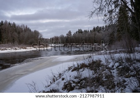 Partly frozen river in cold winter morning, Latvia