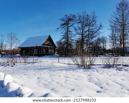 winter day in the Russian village snow well blue sky