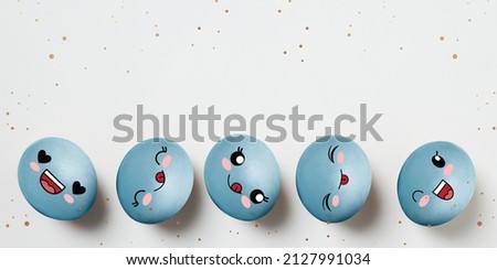 Happy emotions. Blue painted funny cute eggs in cartoon style. Happy Easter traditions, mood. Concept of holidays, spring, celebrating, family time, kids, sales. Copy space for ad, text