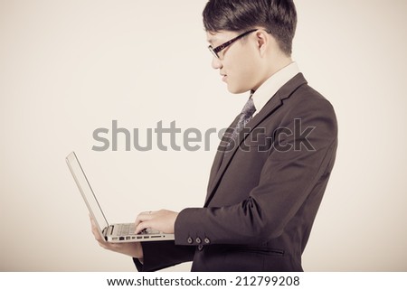 Asian business man using laptop computer isolated on white background
