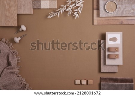 Flat lay of creative architect moodboard composition with samples of textile, paint, panels and tiles. Natural materials. Beige and brown color palette. Top view. Copy space. Template.
