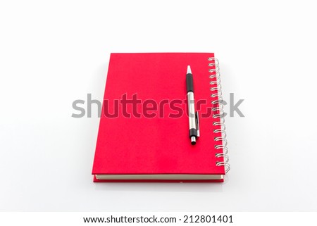 Red spiral notebook with pen on white background. 