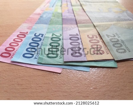 Selective focus of fan-arranged stack of Indonesian currencies called "Rupiah", shoot on low angle
