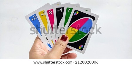 Uno is a colorful card game that includes numbers and symbols. Fun to play with family. Selective focus. 