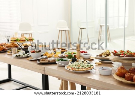 Brunch table setting with different delicious food indoors Royalty-Free Stock Photo #2128033181