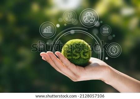 Hand of human holding green earth ESG icon for Environment Social and Governance, World sustainable environment concept. Royalty-Free Stock Photo #2128057106