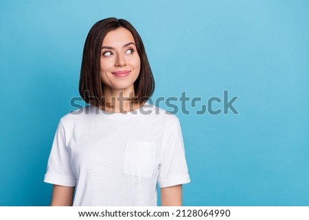 Photo of young attractive woman look empty space minded dreamy think isolated over blue color background