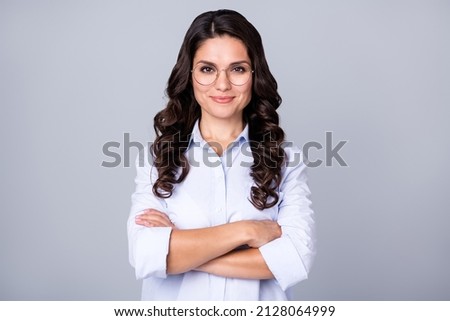Photo of cheerful self-assured lady folded arms wear eyeglasses blue shirt isolated grey color background