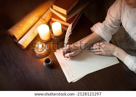 Close up top view past god biblical law mail notice page pray read space. Closeup age male arm hold nib inkwell scribe draw art diary teach notepad card author human man boy dark black wood desk table Royalty-Free Stock Photo #2128121297