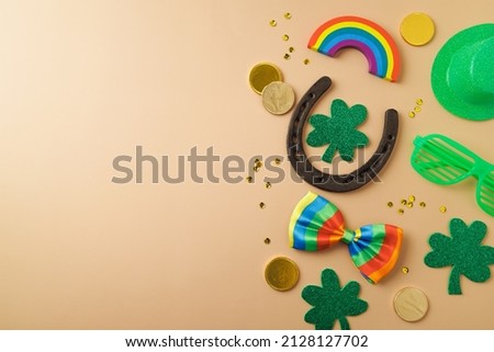 St Patrick's day holiday background with lucky charms, shamrock and  rainbow. Top view with copy space