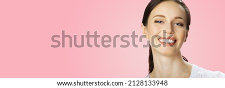 Portrait of very happy, amazed, excited smiling beautiful woman, on rose pink. Attractive brunette girl at studio image. Wide banner horizontal composition. Dental care ad concept.