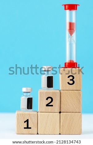  bottles, containers of medicines, vaccines.wooden cubes, medical icons.clock. Healthcare concept.Virus protection, vaccination concept. duration of the vaccine concept