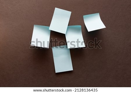 blank blue stickers for notes on a dark surface. High quality photo