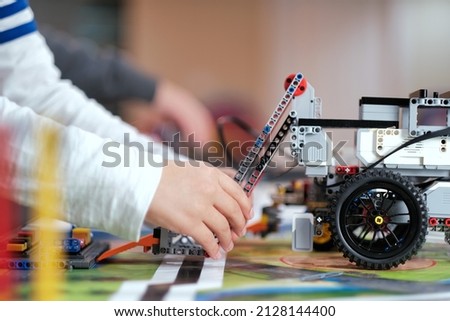 Close up of school students designing and testing STEM robot vehicle project model in robotics class for the competition. Science, technology, innovation, creativity, education STEM. Royalty-Free Stock Photo #2128144400
