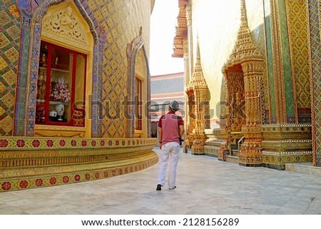 Visitor Walking Along the Circular Pagoda's Base in Wat Ratchabophit Buddhist Temple, Historic Place in Bangkok, Thailand Royalty-Free Stock Photo #2128156289