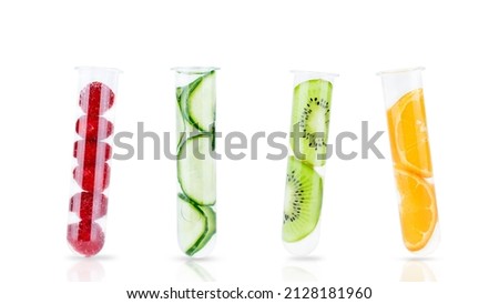 Slices of cucumber, kiwi, orange and raspberries in test tubes isolated on white. Natural cosmetics, natural, alternative medicine concept Royalty-Free Stock Photo #2128181960
