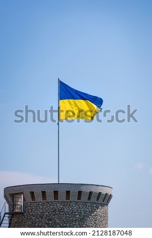 Ukraine flag isolated on the blue sky. Close up waving flag of Ukraine. Flag symbols of Ukraine.