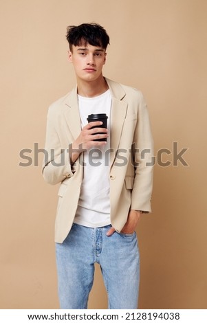 handsome guy black disposable glass in the hands of posing fashion isolated background unaltered