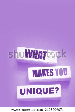 What makes yiu unique - phrase on Wooden blocks. Business or carees success concept.